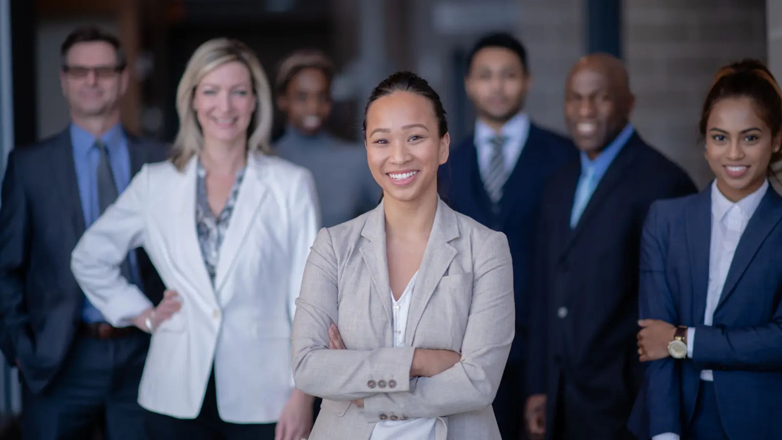 professional presence blog image shows 7 people in business suits standing confidently and looking into the camera