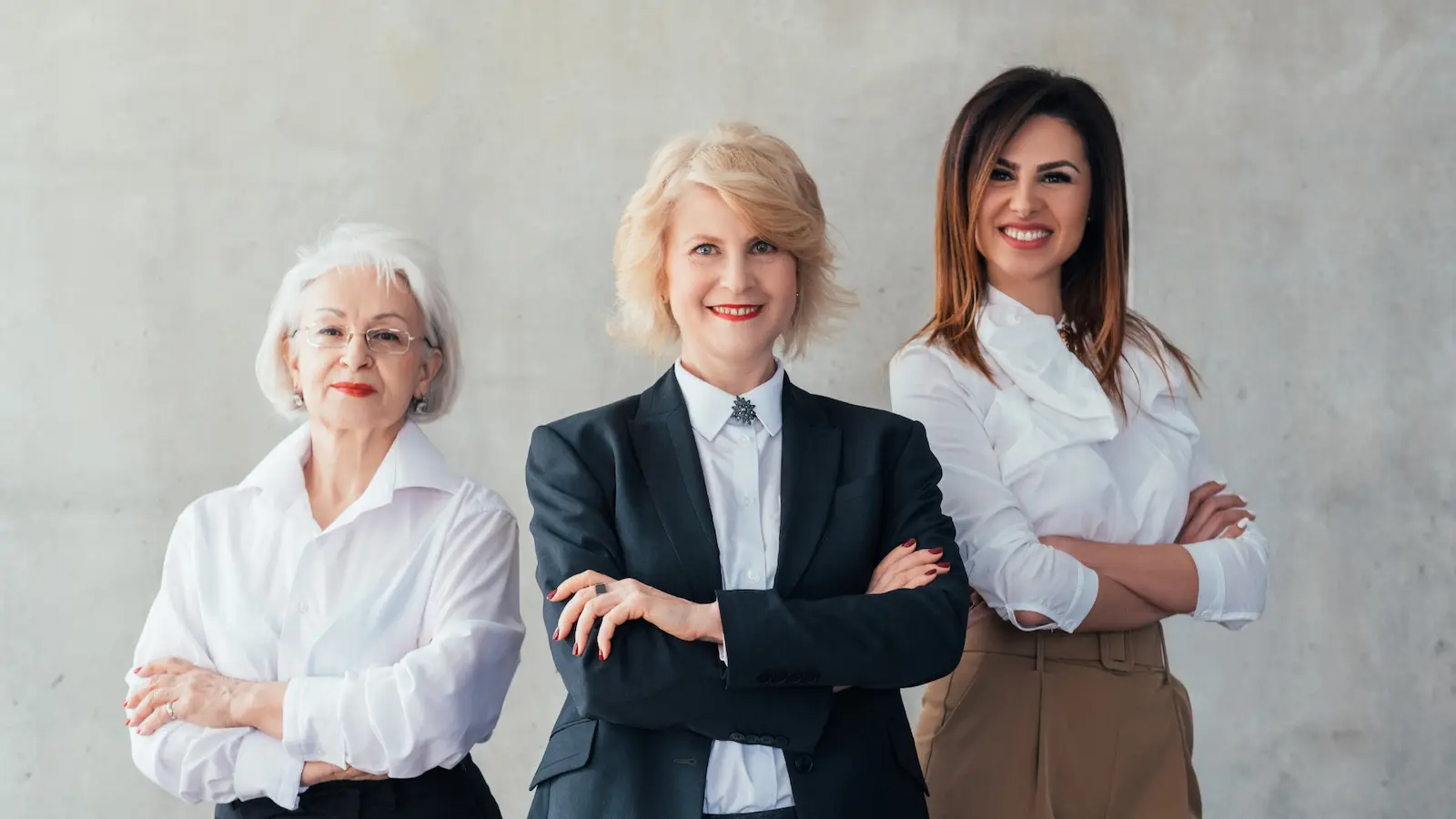 5 big life pillars image shows 3 professional woman standing confidently, wearing red lipstick