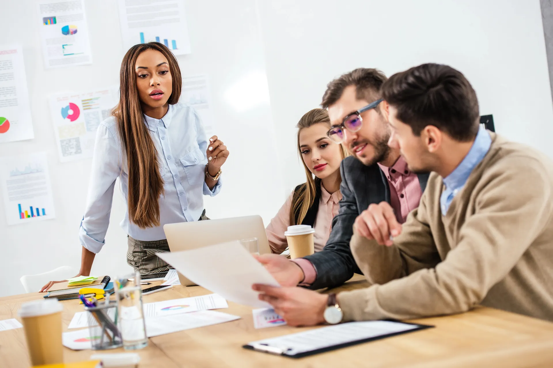 Project Management Skills for Assistants image shows a professional woman leading a meeting